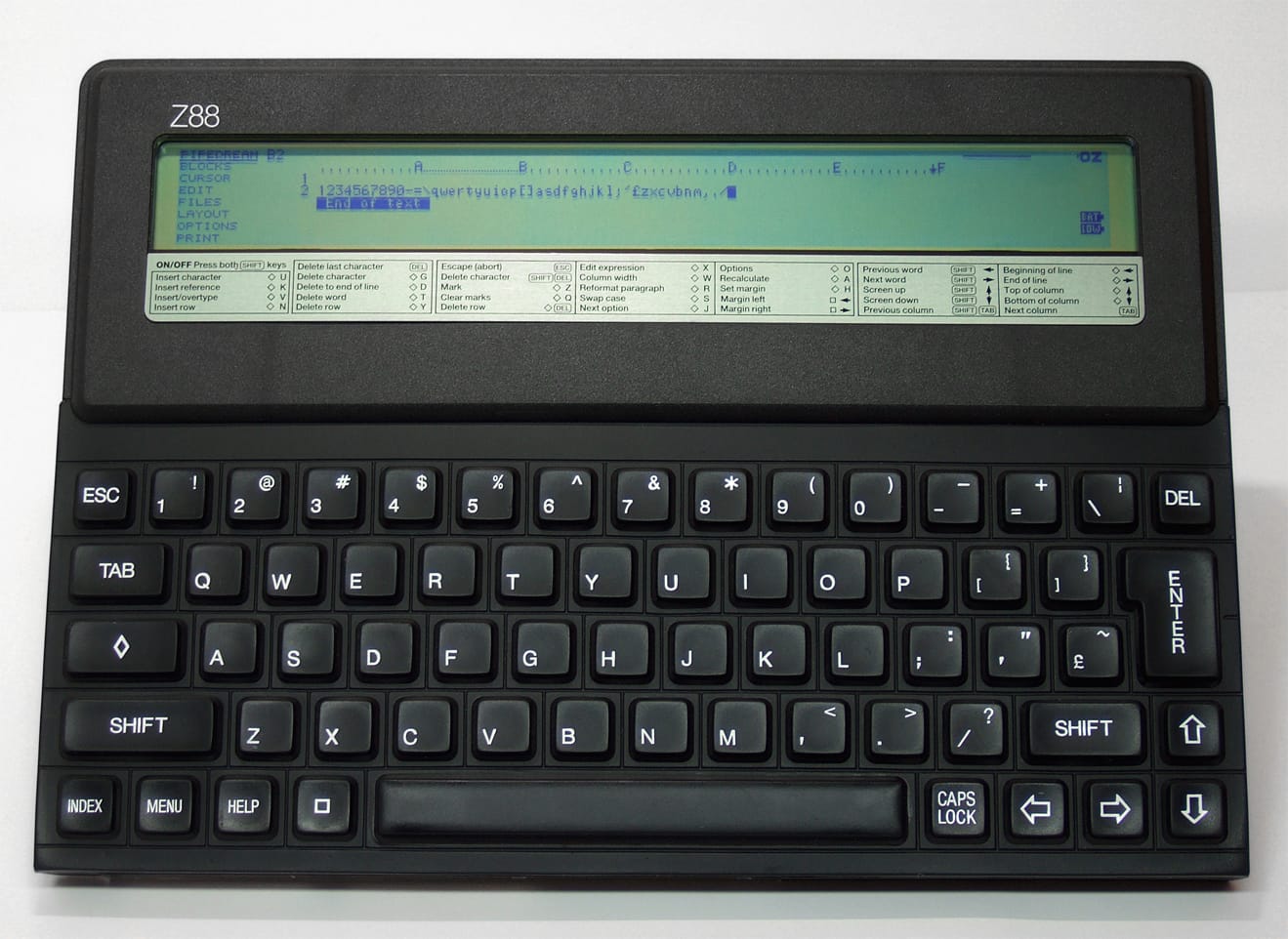 The Cambridge Z88, a flat slab of black, textured plastic with full keyboard and arrow keys. The screen at the top of the slab is 8 lines tall, 80 characters wide. PipeDream is running on it, showing text input and the familiar spreadsheet row/column identifiers. It's a more compact, usable amount of visual space than the TRS-80 Model 100, for sure.
