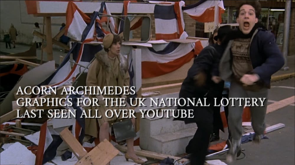 Tom Hulce running away from his girlfriend's angry father. Caption reads, "Acorn Archimedes. Graphics for the UK National Lottery. Last seen all over YouTube."
