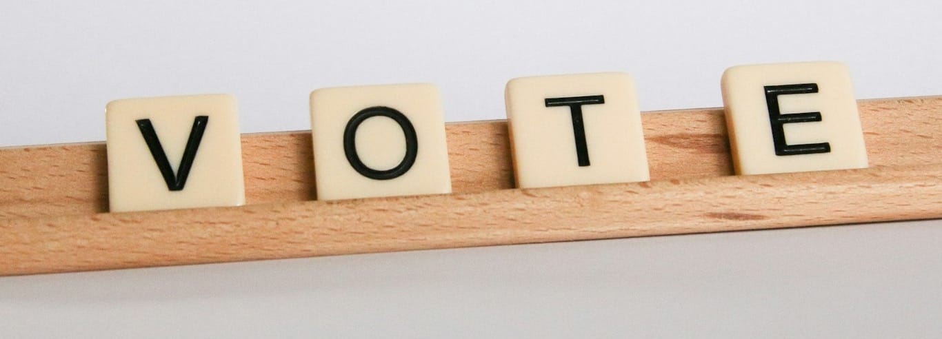 V-O-T-E in Scrabble tiles
