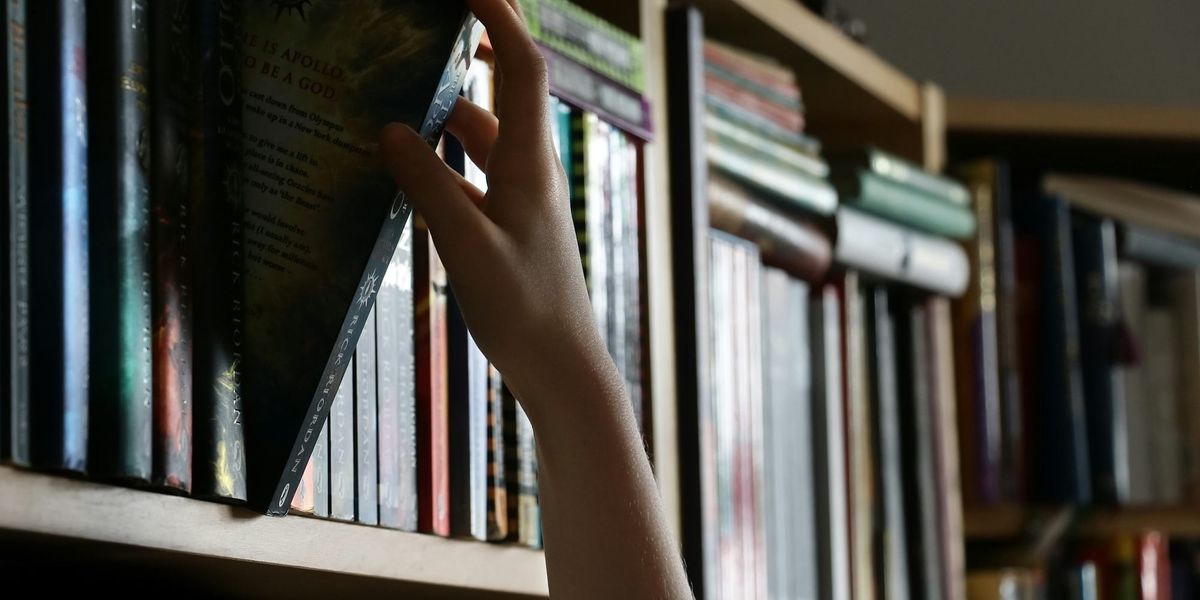 Pulling a book off the library shelf