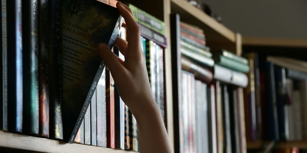 Pulling a book off the library shelf