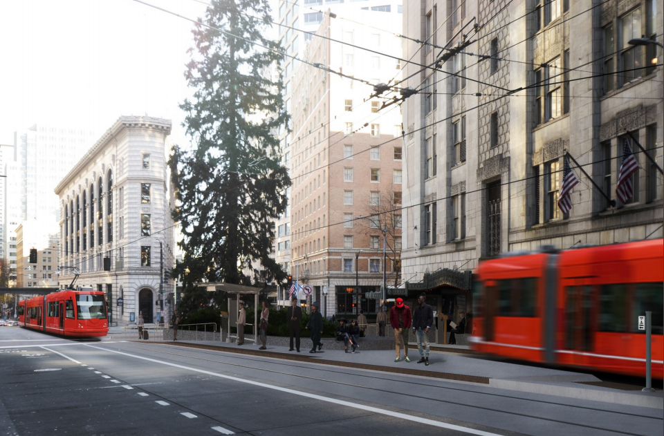 A photo a red streetcar running in downtown Seattle.