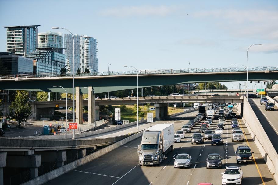 The new East Link bridge soars about I-405 traffic with existing crossings to the south in the background. (Credit: Sound Transit)
