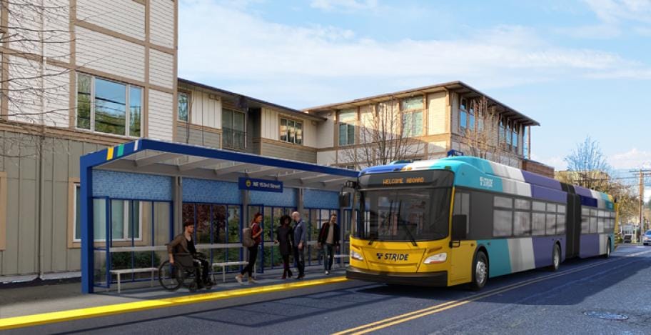 A bus stop including a half dozen waiting passenger including one in a wheelchair as a yellow and light blue bus pulls up.