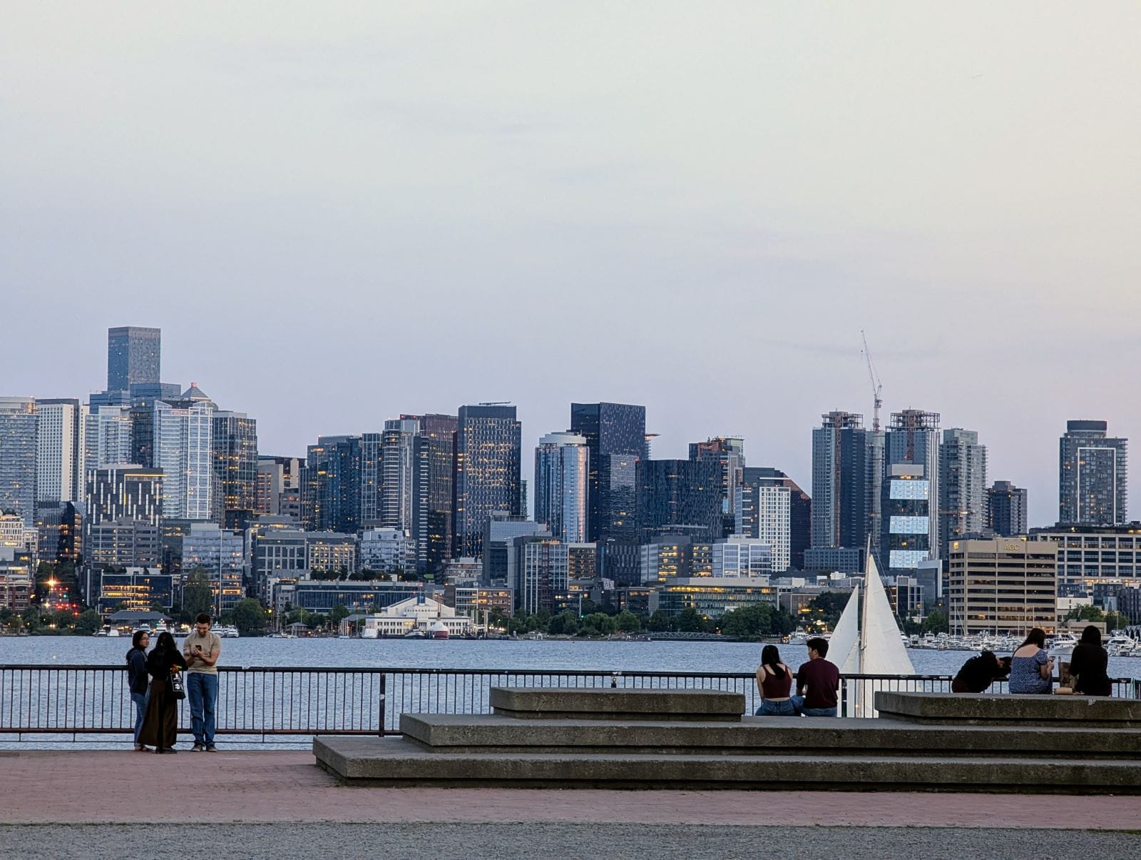 A sailboat passes in front of the seating area at Gas Works with the skyline in the distance