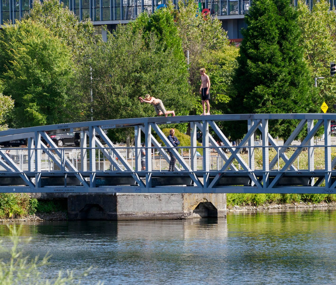 two guys jumping off the top of the ped bridge