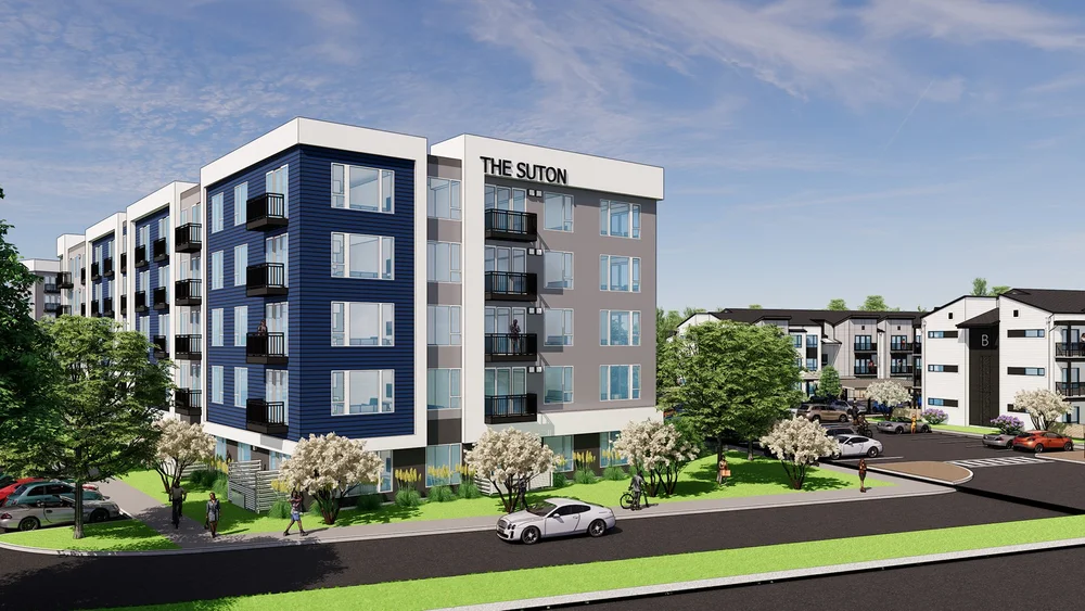 A blue and gray five-story building with a row of trees in front