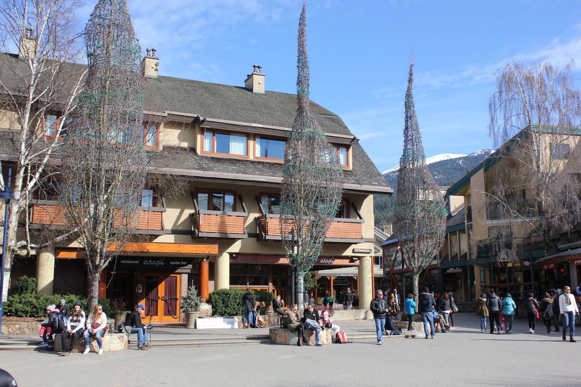 People sitting in one of Whistler's public squares. The low building heights allow views of the mountain. (Photo by Sarah Oberklaid). 