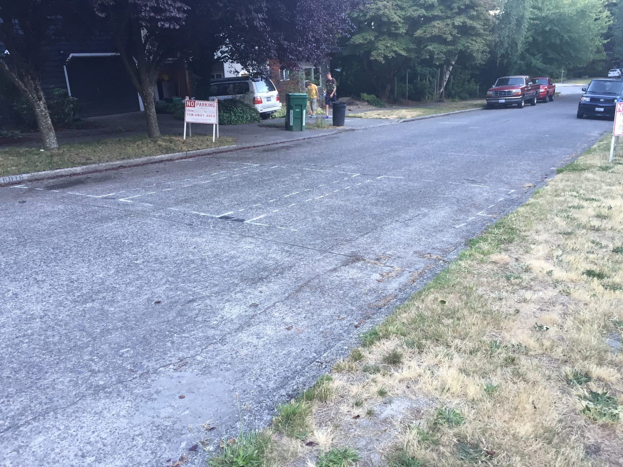 Markings indicating the location of a future speed hump.