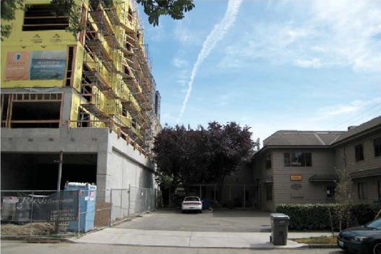 The site is currently occupied by a two story office building and a surface parking lot. (Caron Architecture)