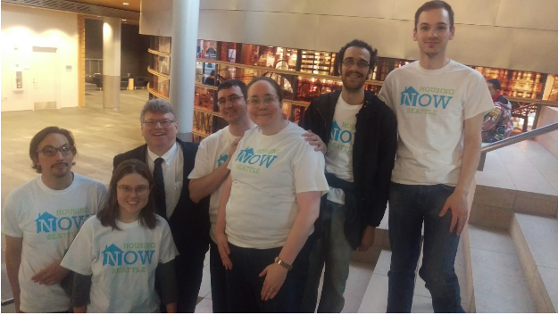 Housing Now volunteers heroically ascend the steps of city hall in their bold yet stylish shirts. (10/25/2016)
