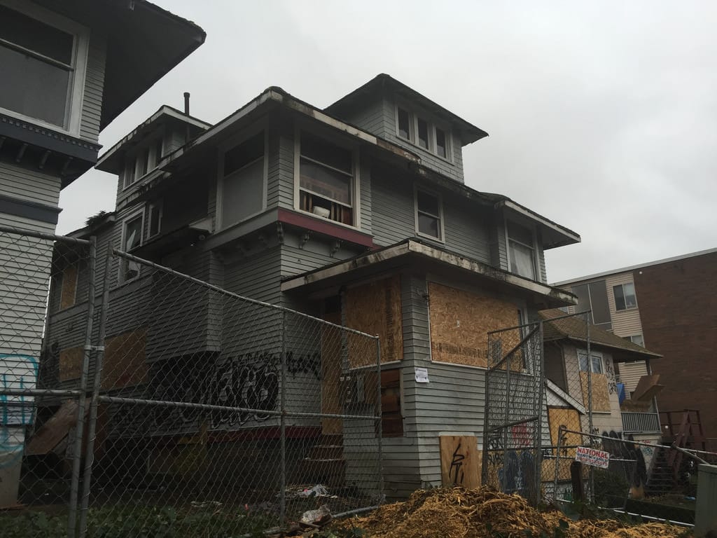 Vacant residences on Brooklyn Ave NE, which housed more than a dozen residents; one structure will be restored and transformed with a seven-story building wrapping around it. (Photo by Stephen Fesler)