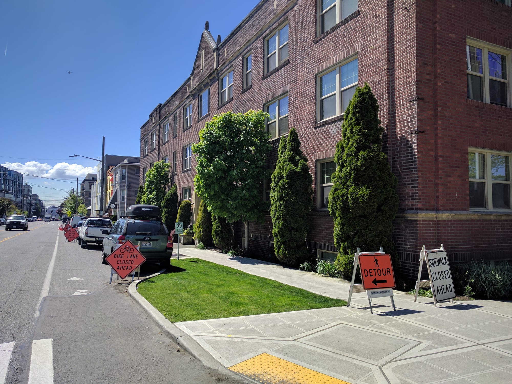 The bike lane and sidewalk are both blocked by construction.