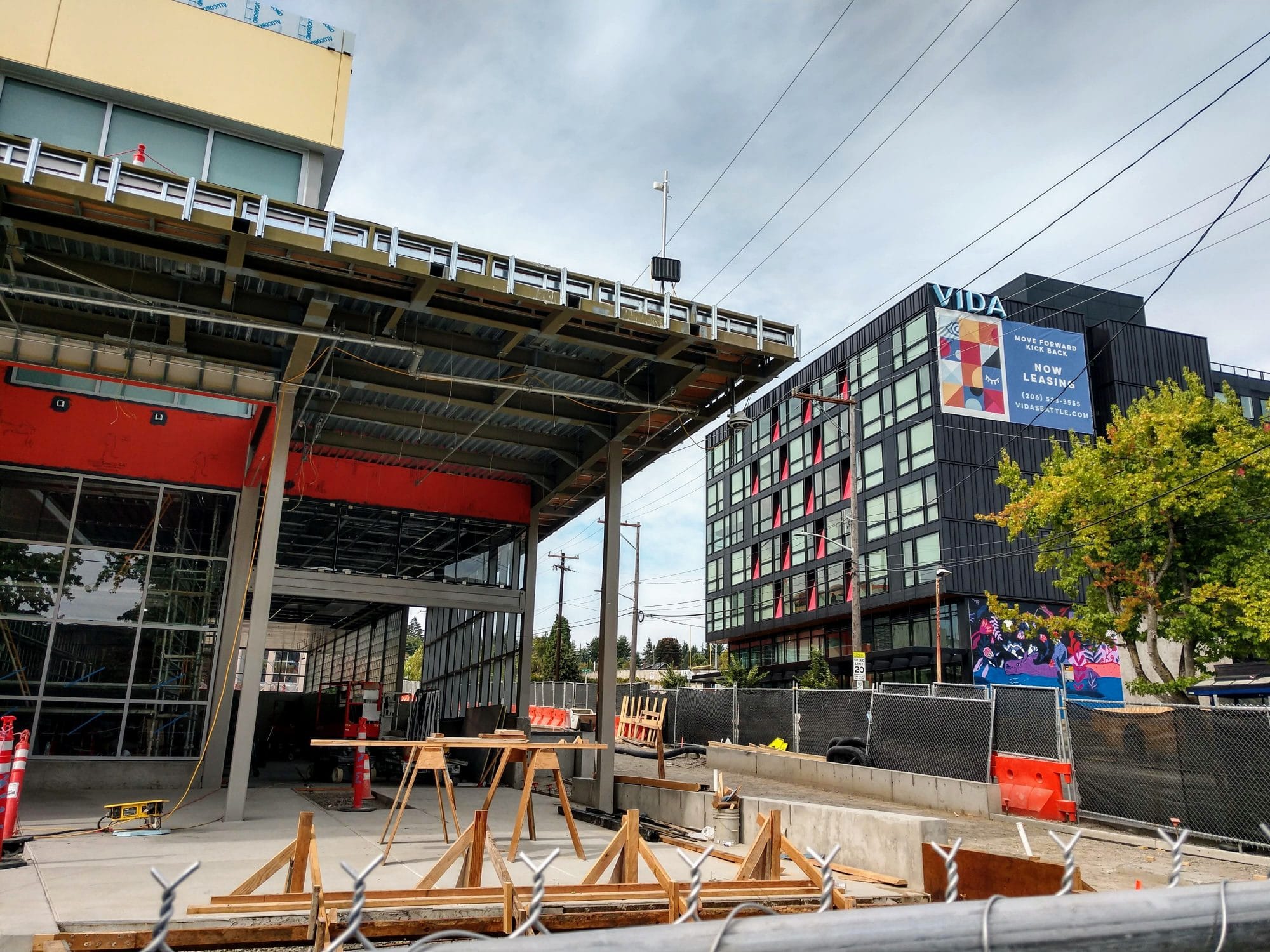 
                     Roosevelt light rail station entrance with a 6-story apartment building in the background.
                     