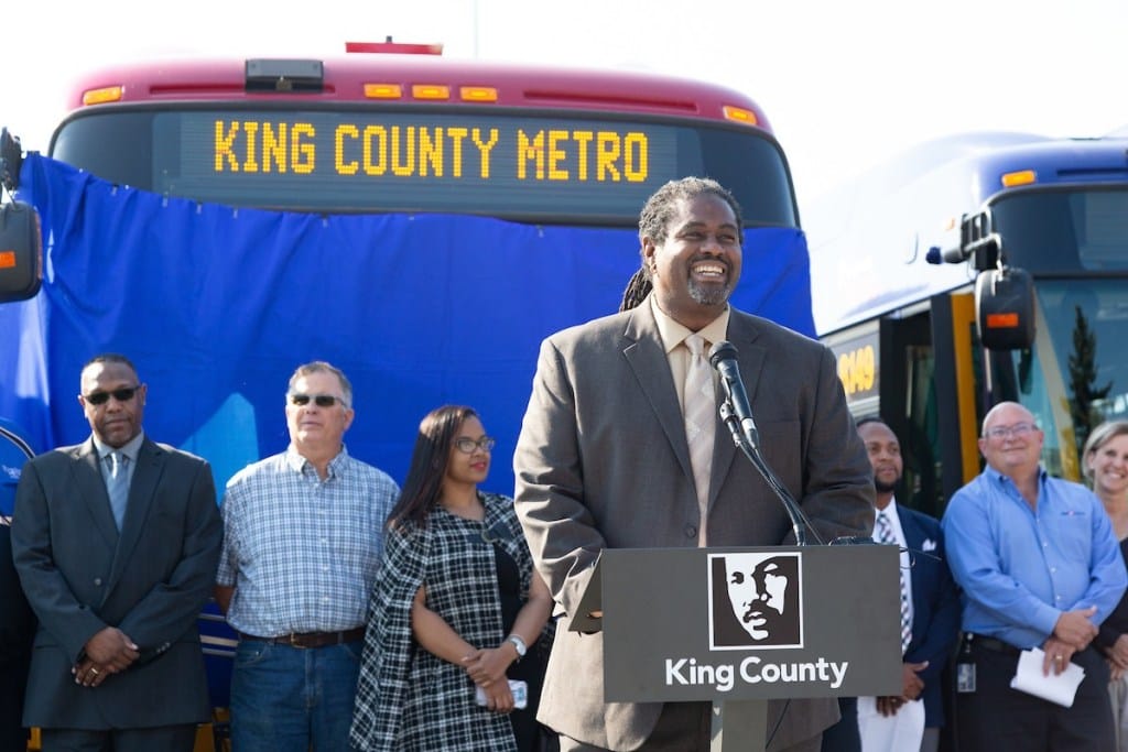 
                     Terry White at a podium in front of a Metro bus flanked by Metro coworkers at a 2018 event.
                     