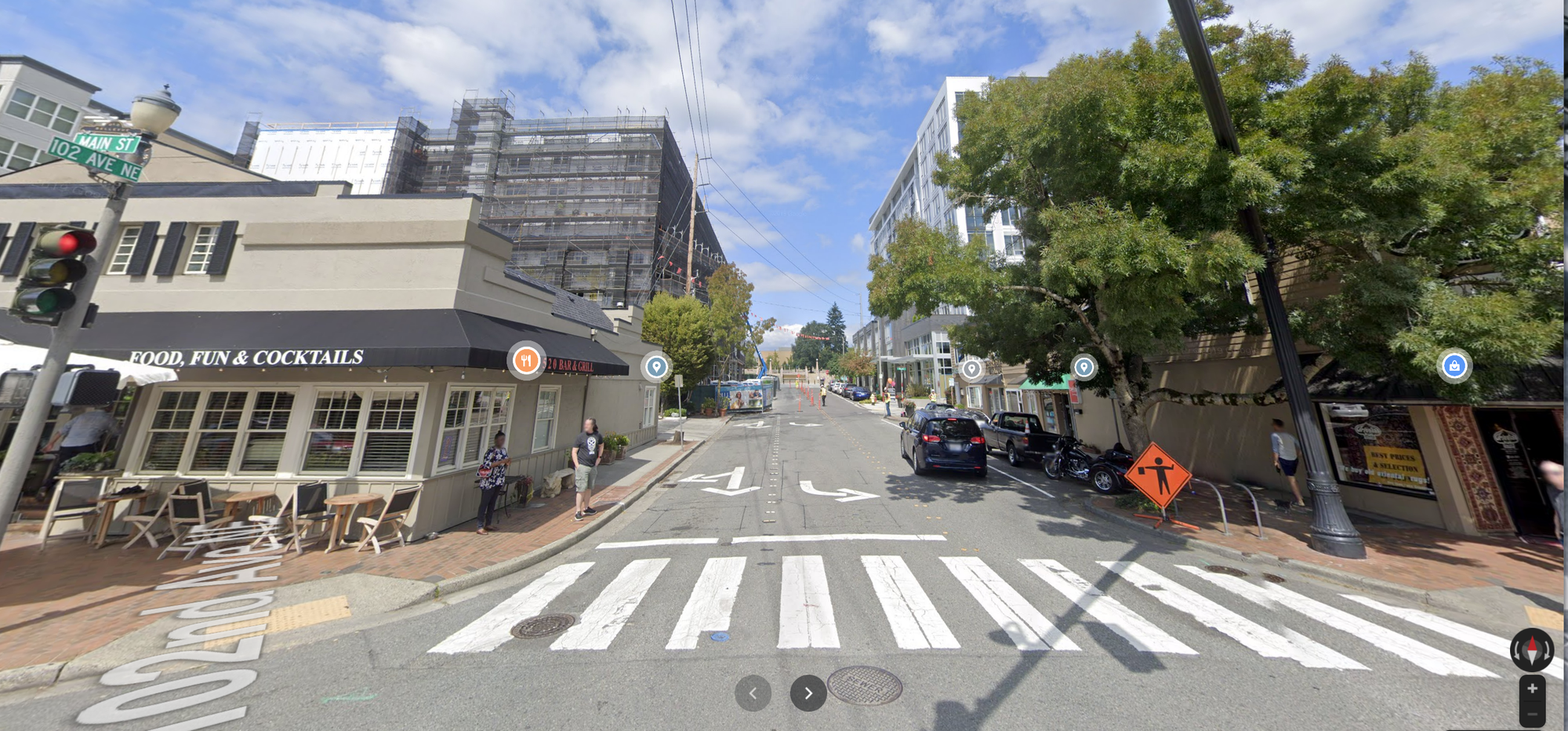 A view of a pedestrian crossing on a commercial street. 