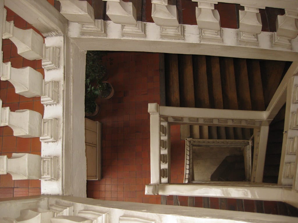
                     A photo looking down a multi-level staircase
                     