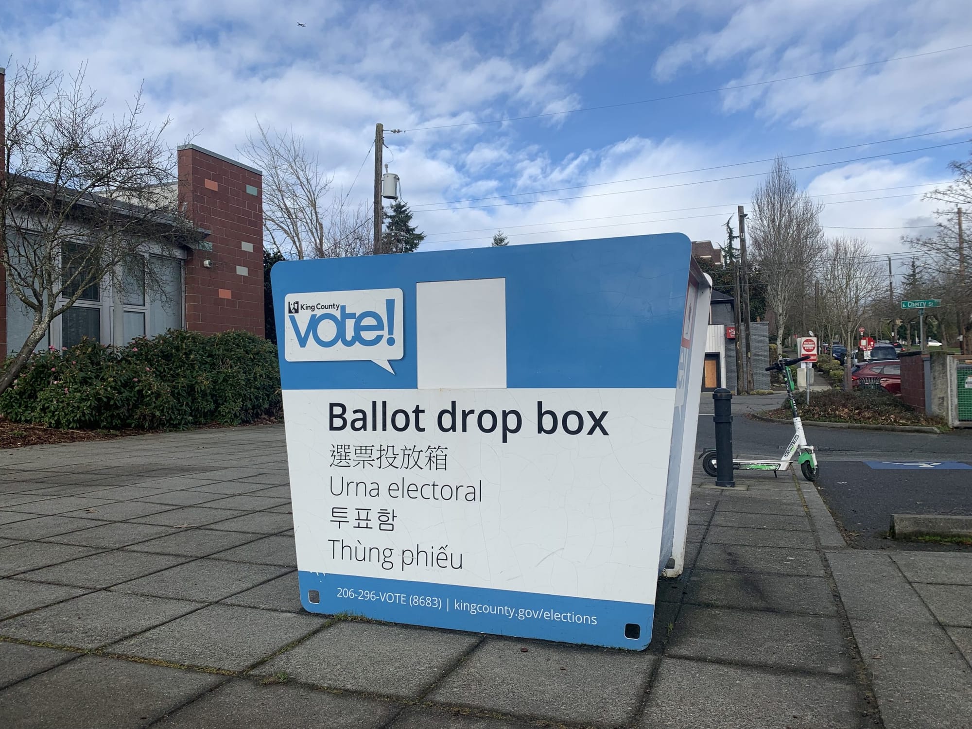 
                     A photo of King County ballot drop box on a sunny day.
                     