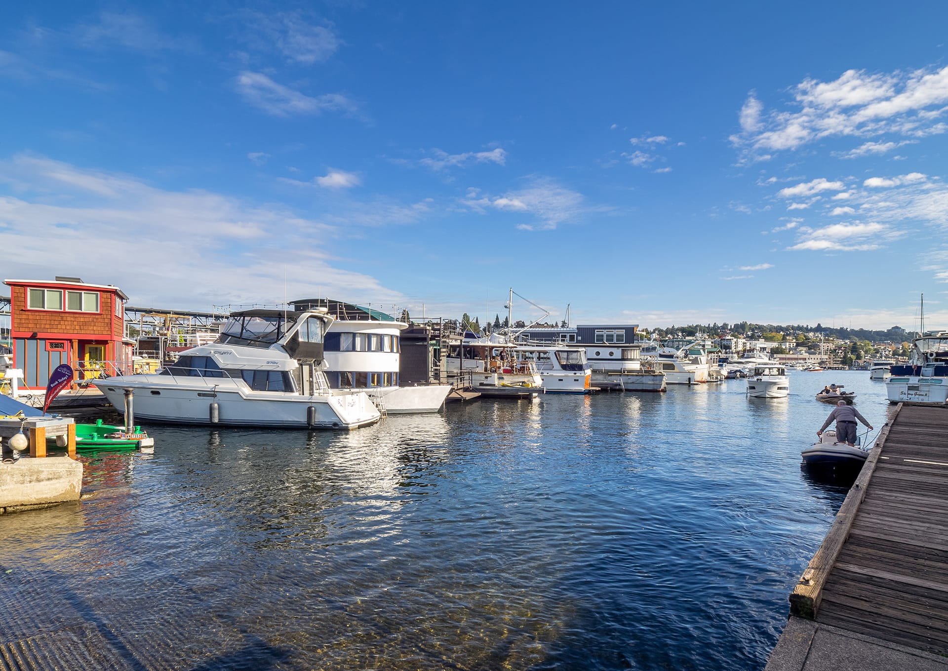 A photo of a boat ramp, lake, and boats.