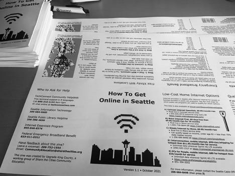 
                     A black and white photo of a flyer instructing how to get online in Seattle.
                     