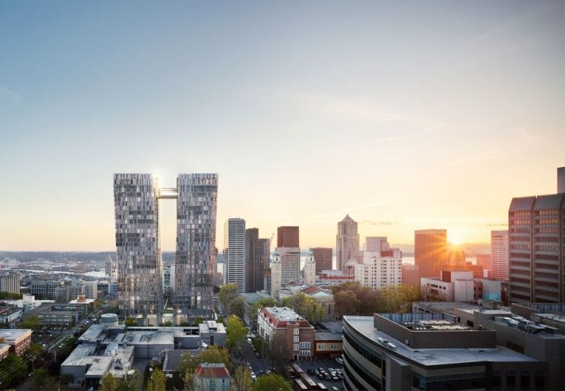 A photo of first hill with a rendering of two tall glass towers imposed on it. 