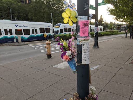 
                     The photo is of a heartbreaking memorial of flowers and floral pinwheels left on a light pole by Jennette’s loved ones near w
                     