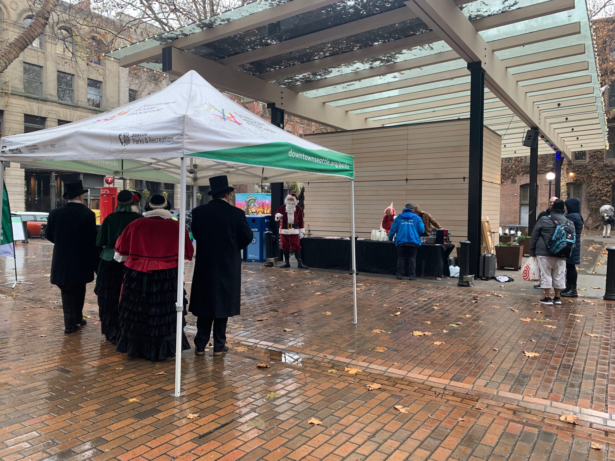 Carolers sing under a tent