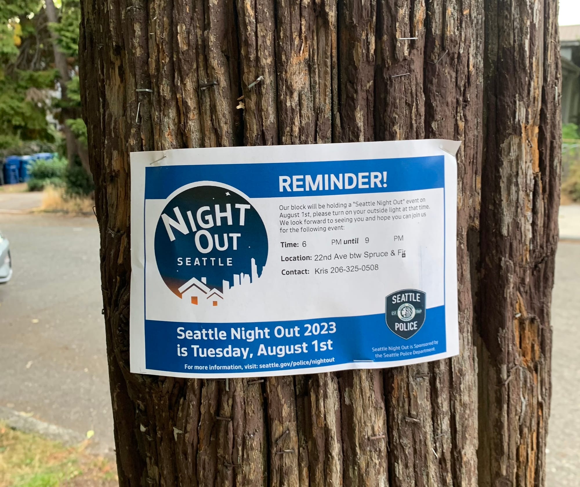 A telephone post has an reminder for Seattle Night Out 2023.