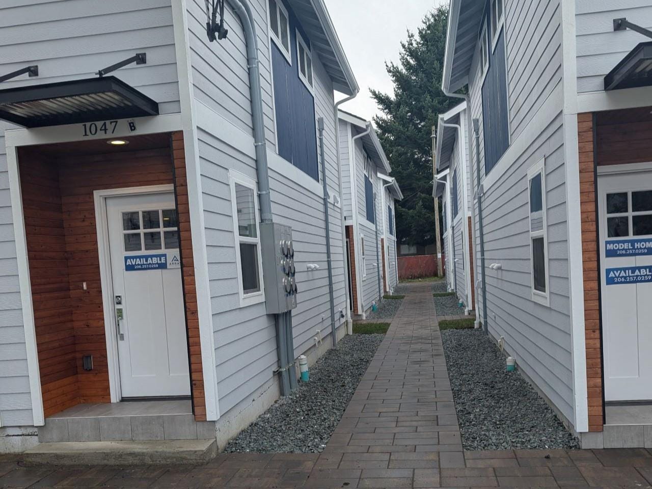 A paver alley down the middle of the six stand alone townhomes.