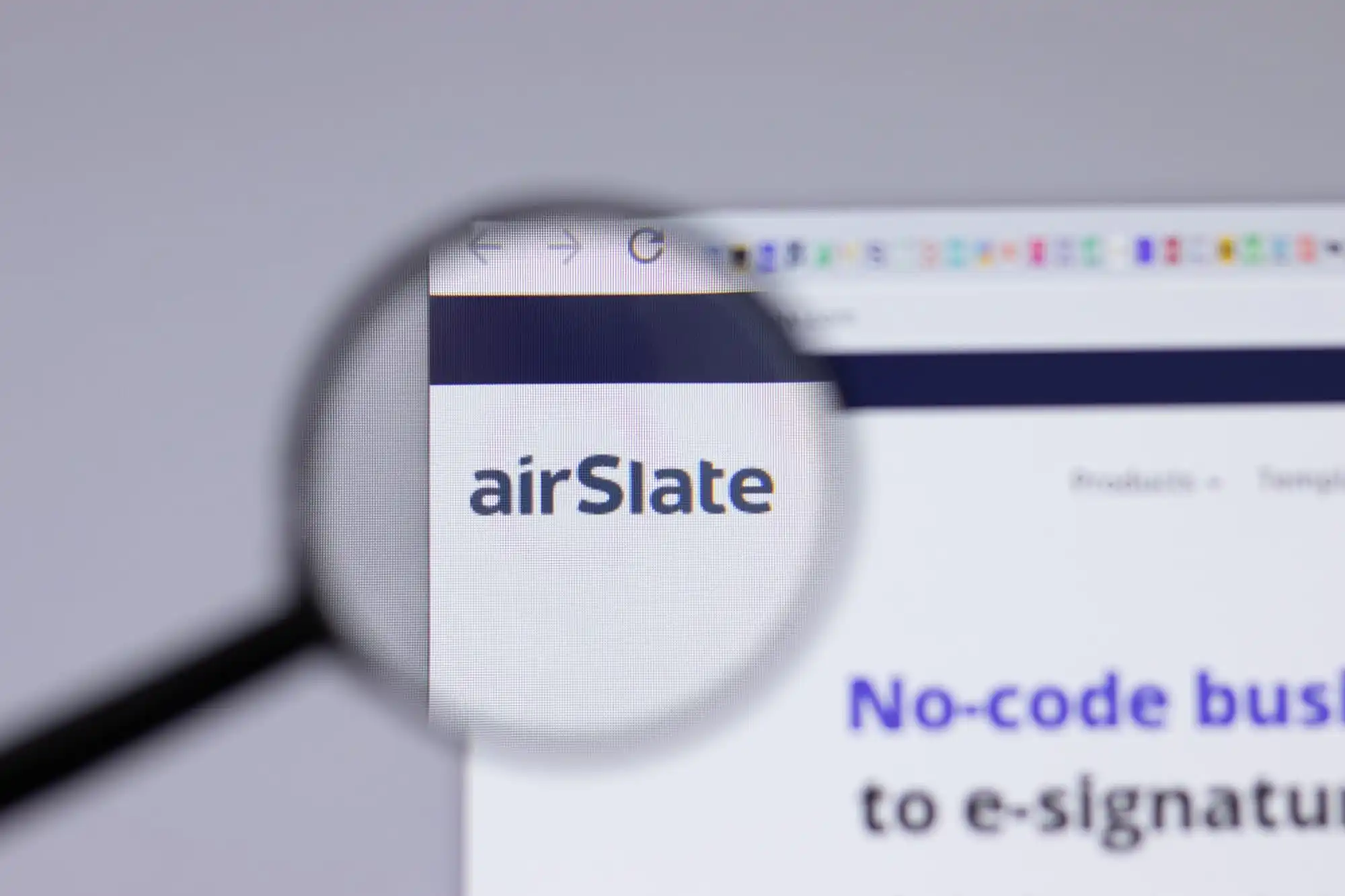 magnifying glass zooming in on the AirSlate name on the website