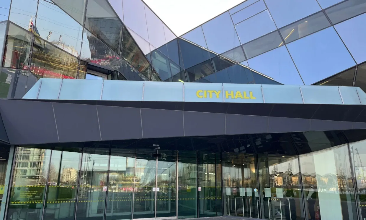 The exterior of City Hall, an angular glass building.