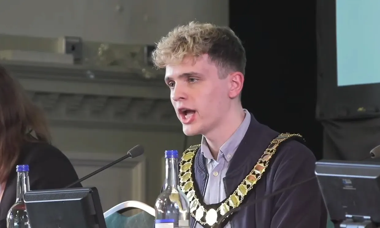 Photograph of Green councillor Nate Higgins speaking at his first meeting as chair of Newham Council, 20 May 2026.