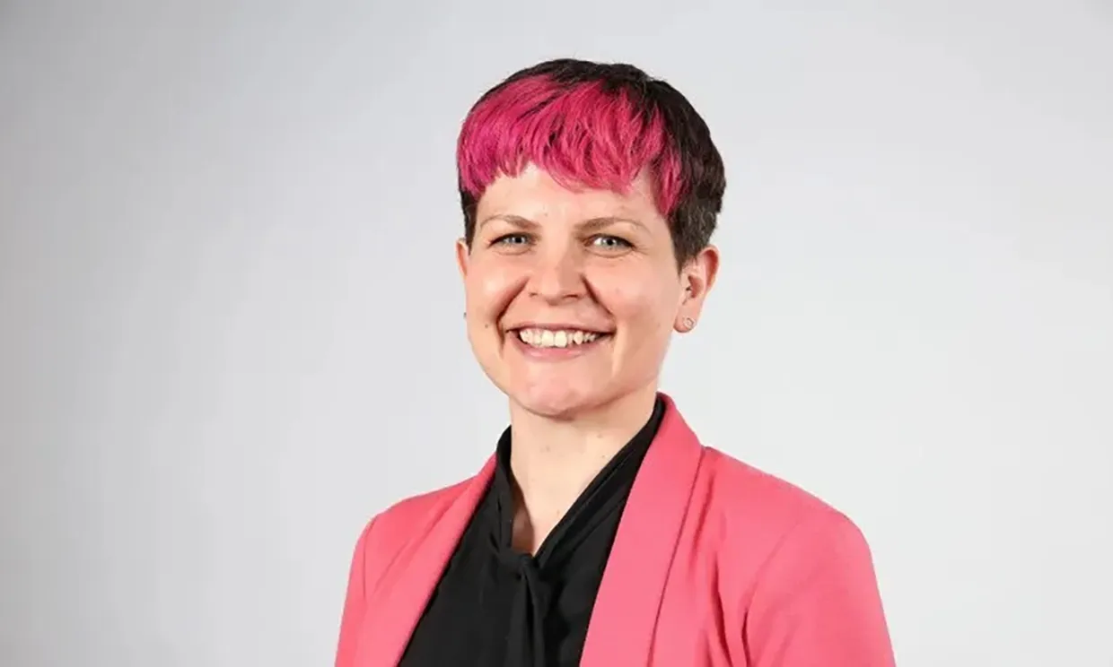 Close up of Zoe Garbett smiling in a headshot style photo.