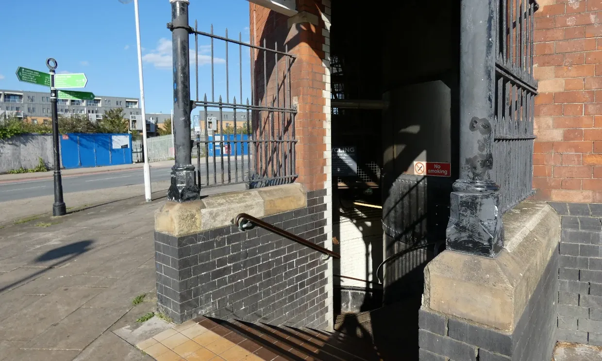 Stairs lead into the bricked circular building