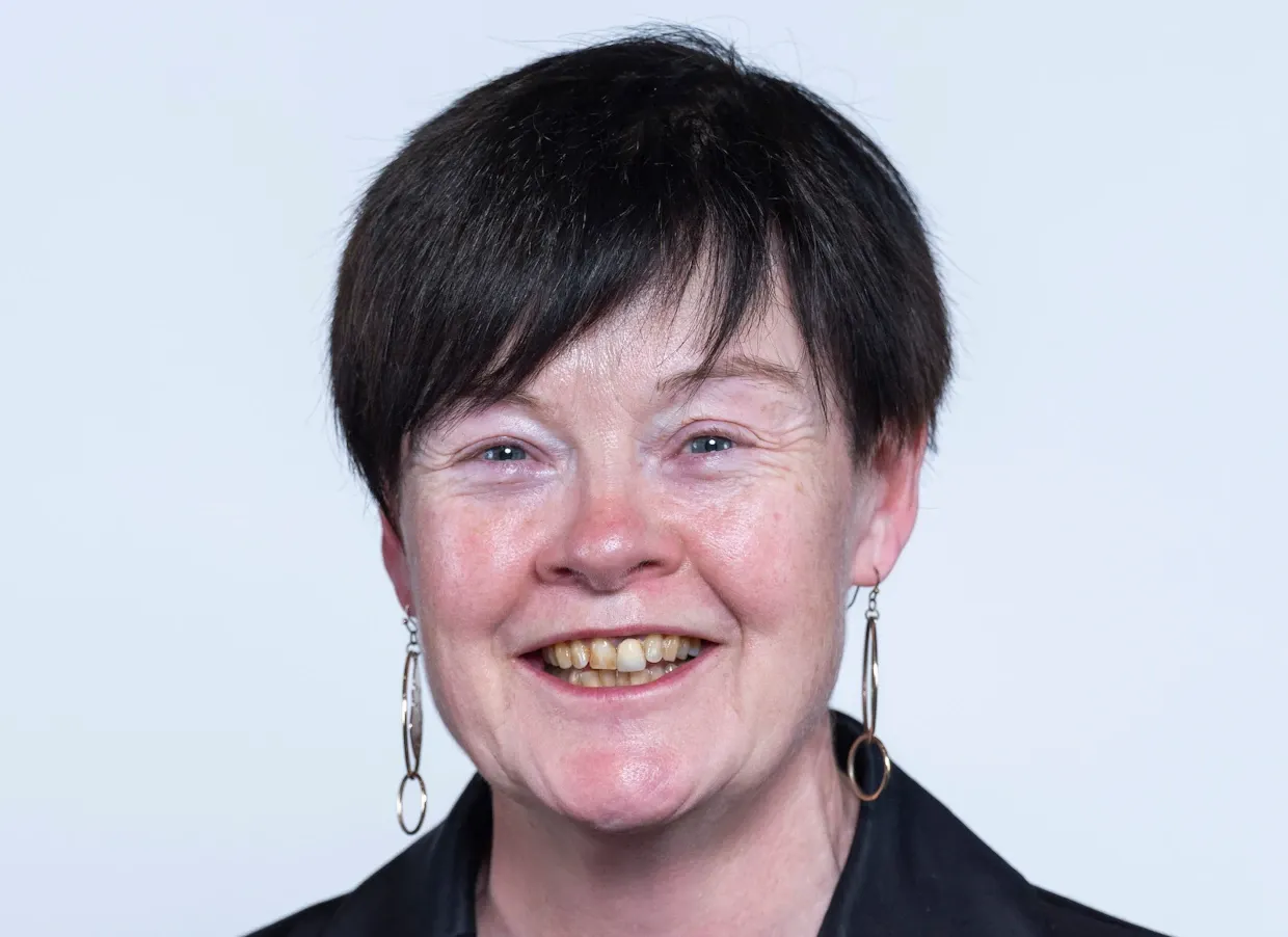 A close up shot of Susan Masters smiling to camera