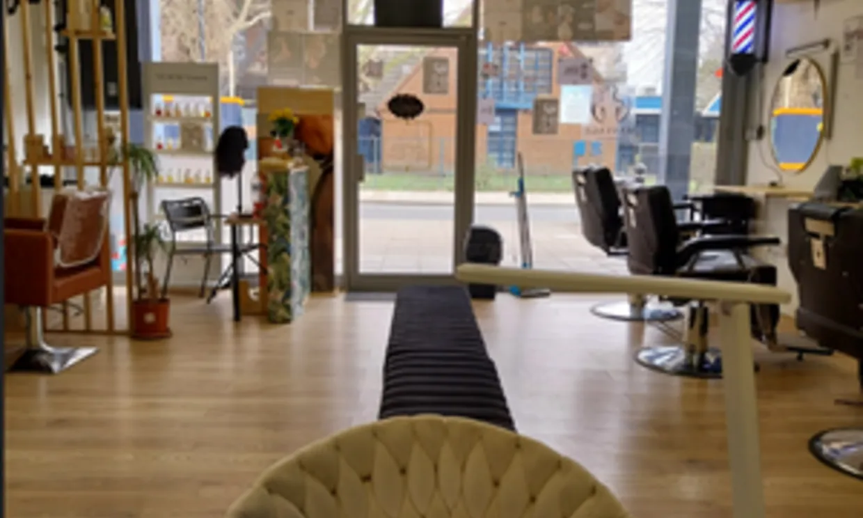 A photo of the inside of the salon, with salon chairs and mirrors.