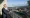 Sadiq Khan standing on a balcony looking over a housing complex