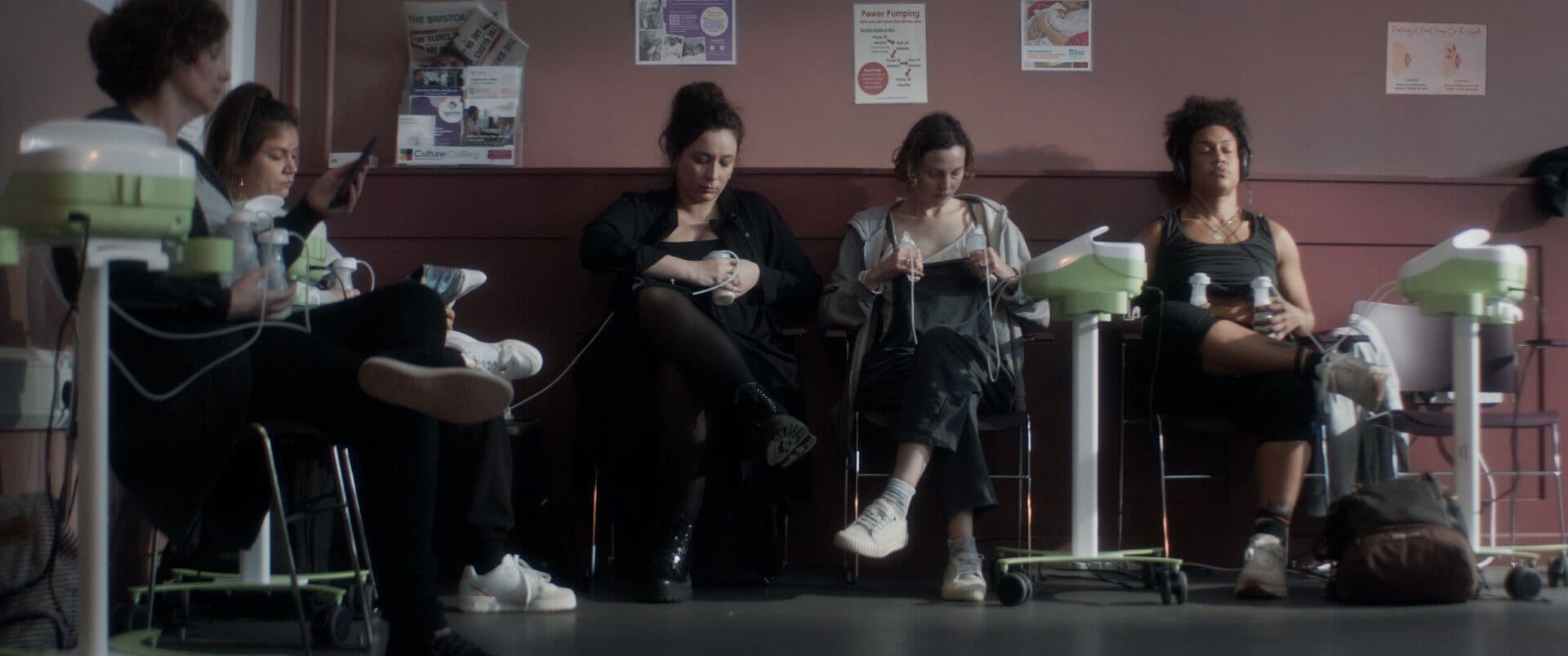 Still from short film 'Pump Off'; women sitting using breast pumps.