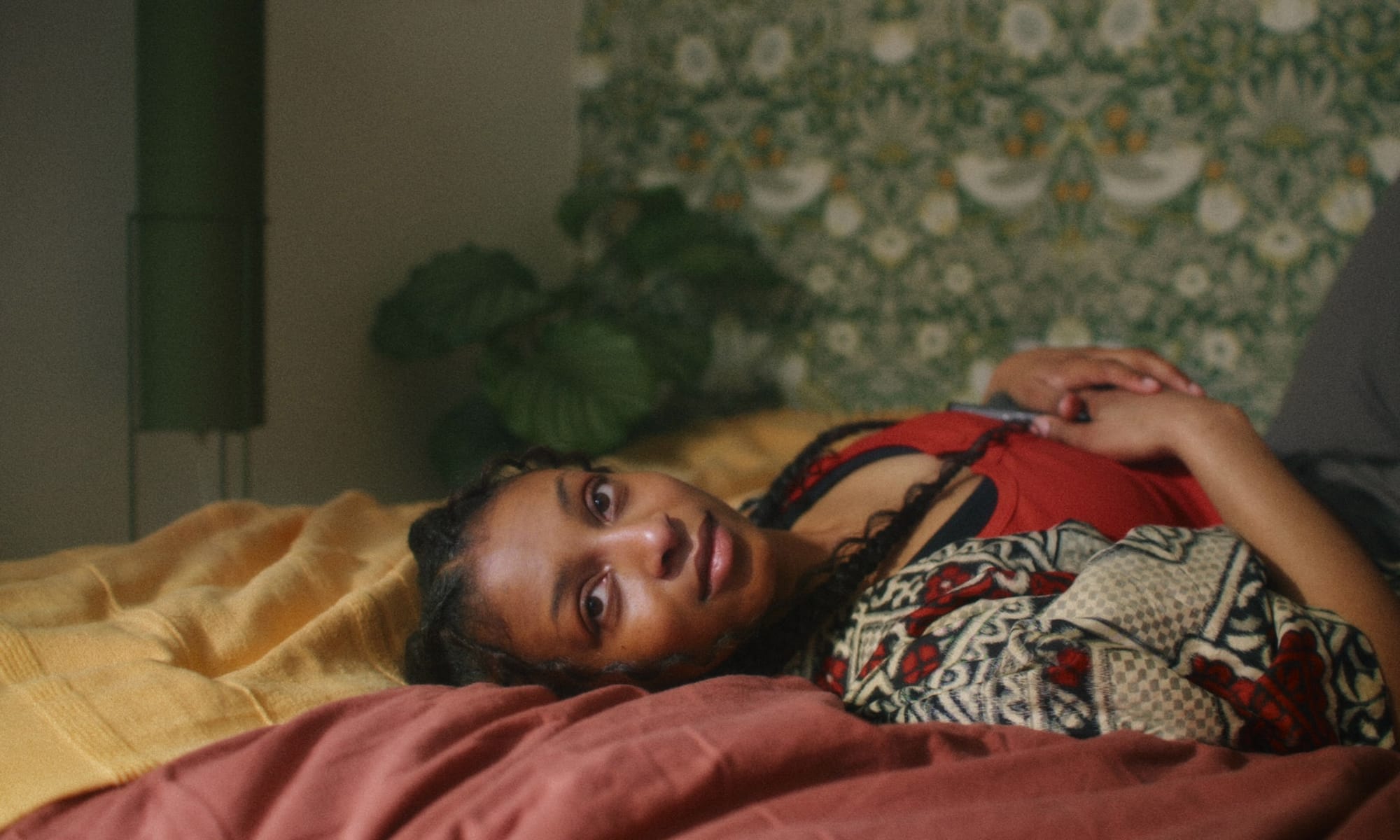 Actor lying on a bed looking to the side