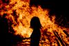 Woman in front of fire