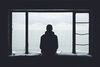 Man staring through window.