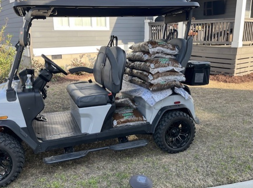 Rover XL with cargo bed stacked with bags for a yard project