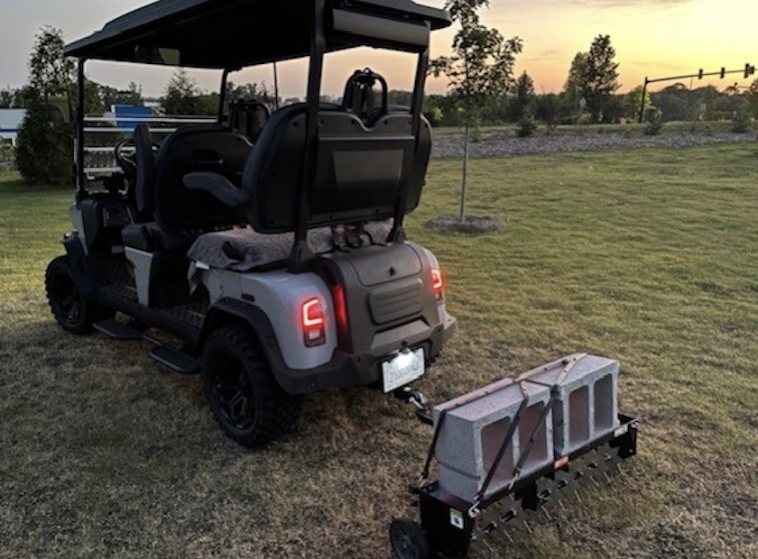 Rover XL pulling a trailer of bricks at sunset