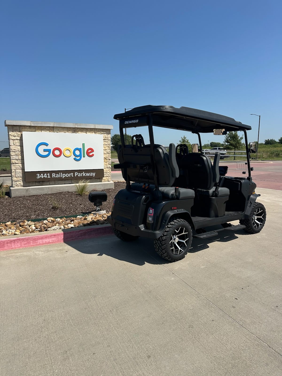 Black Denago six-seat golf cart parked at the Google data center sign, 3441 Railport Parkway, Midlothian, Texas