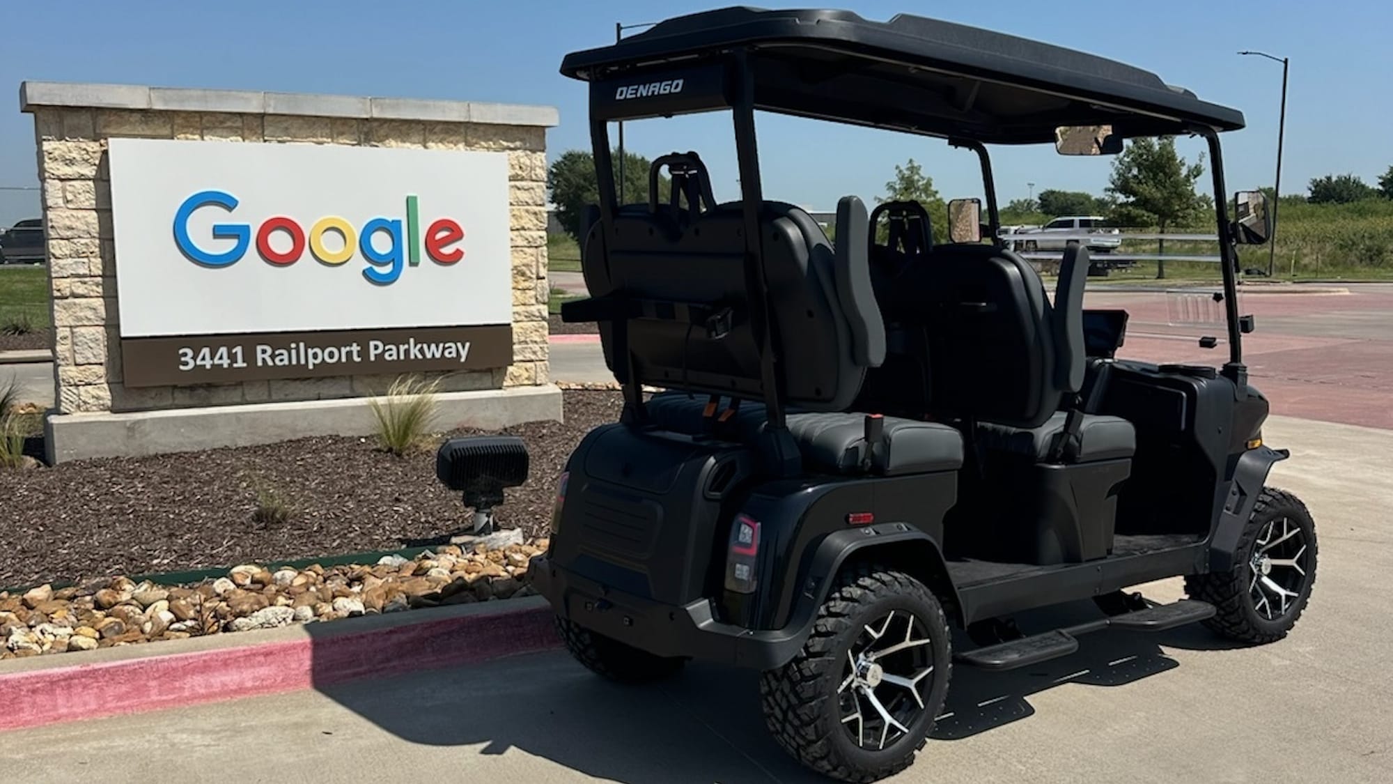 Black Denago golf cart parked in front of the Google data center sign at 3441 Railport Parkway, Midlothian, Texas