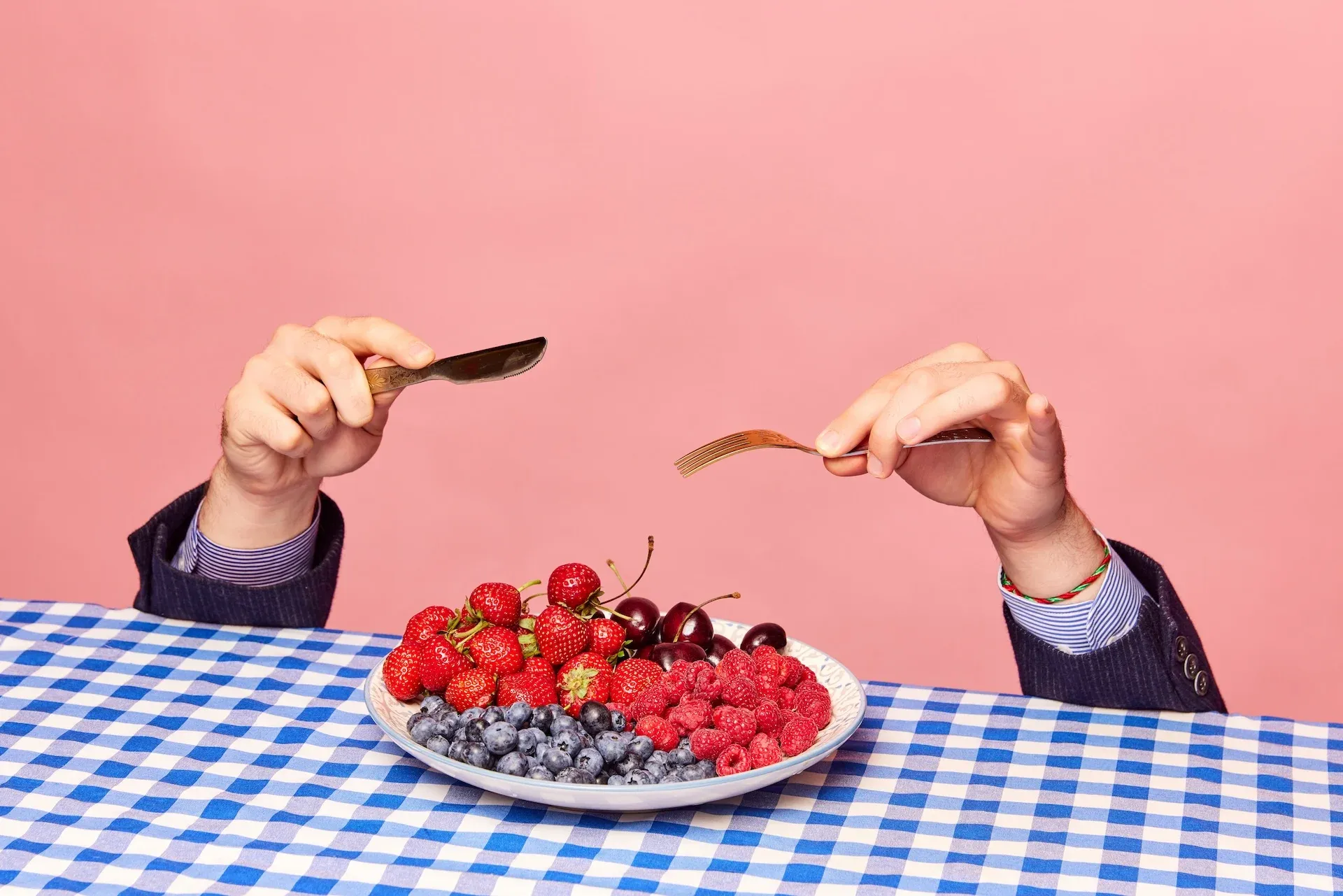 Eating berries from a plate 