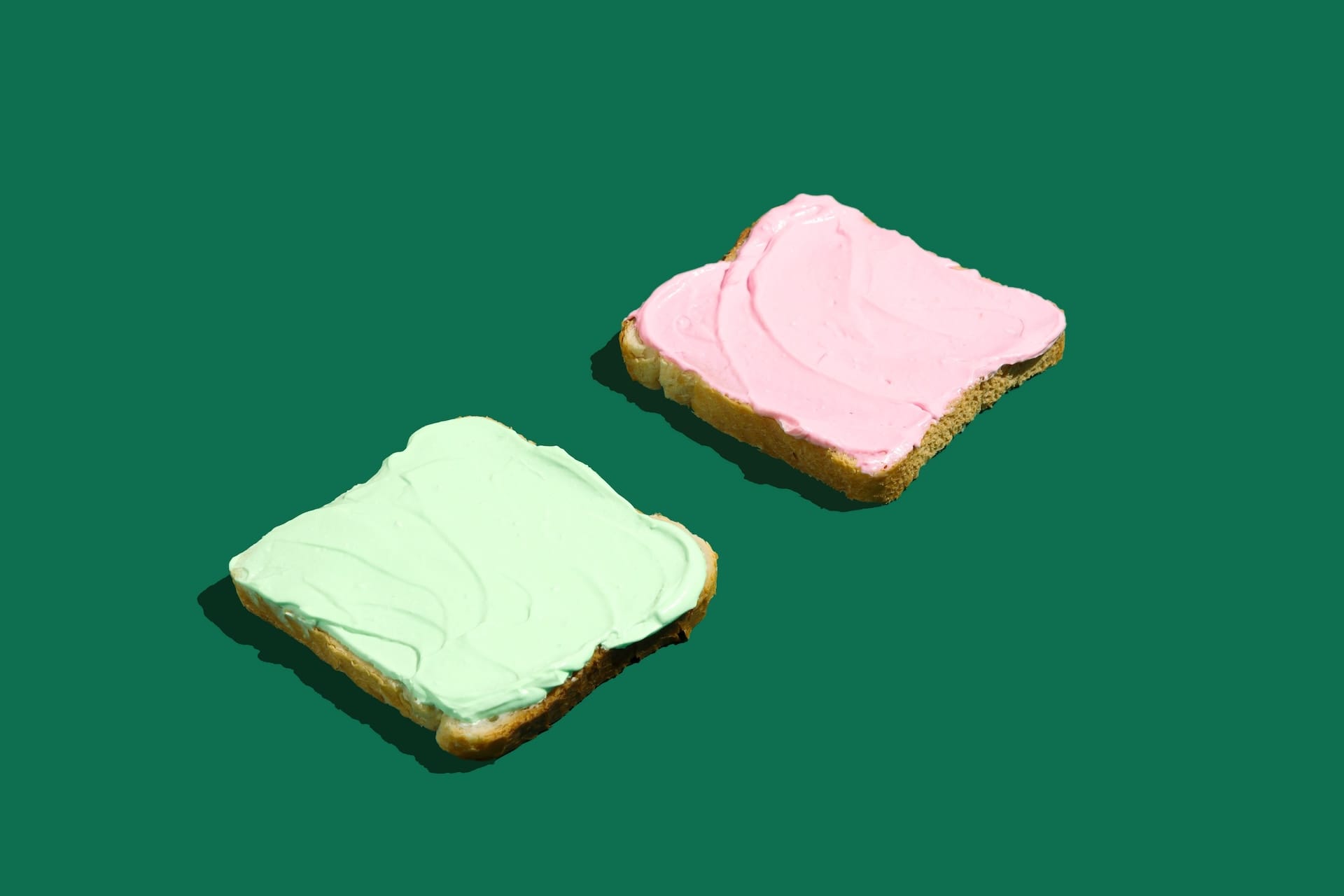 Two pieces of toast covered in colorful spread
