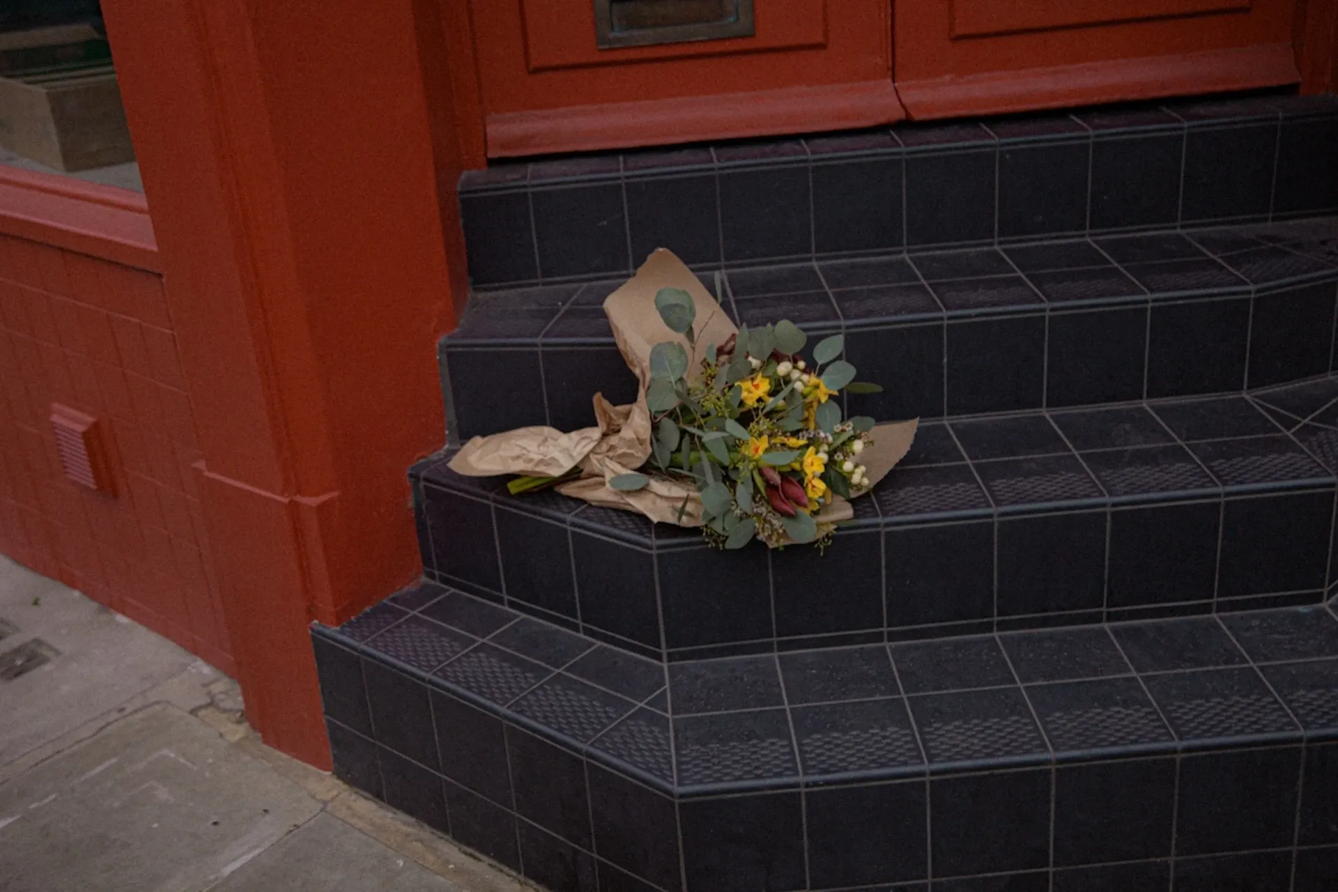 A bunch of flowers on a doorstep