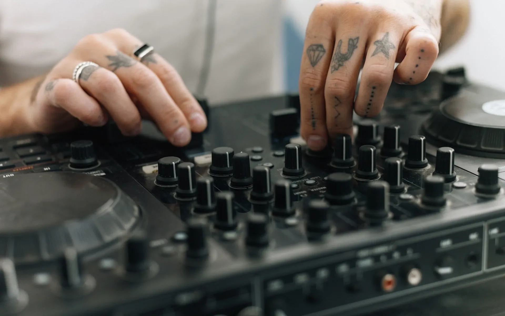 Tattooed person DJ-ing