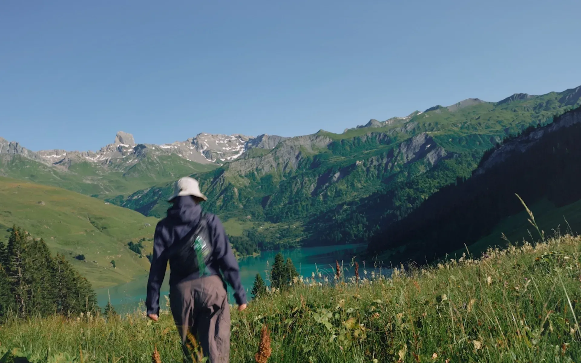 Person hiking through the mountains on a sunny day